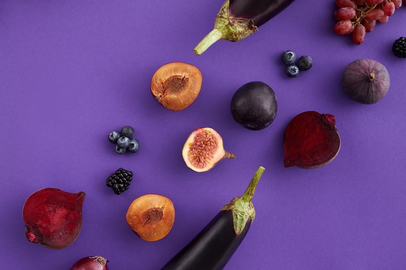 Photo composition of aubergines, figs, blueberries, grapes that originally are purple, but seen as greyish purple or grey with protanopia